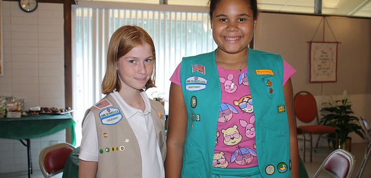 Alexandria Anderson-Whitteaker and Tatiana Connelly served the potluck dinner and lemonade with their two scout leaders.