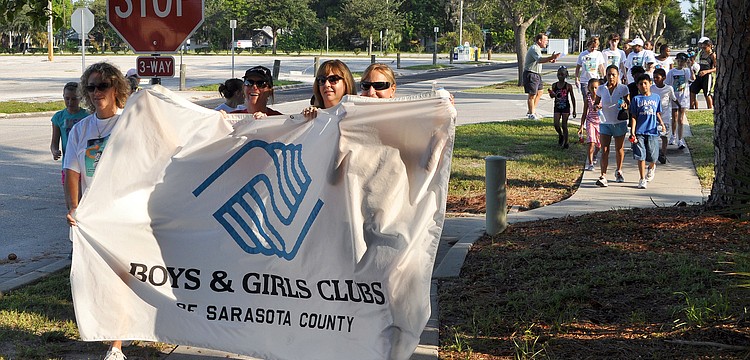 A few people held the banner and led the Walk for the Kids Saturday, Sept. 18, at the Lee Wetherington Boys and Girls Club.
