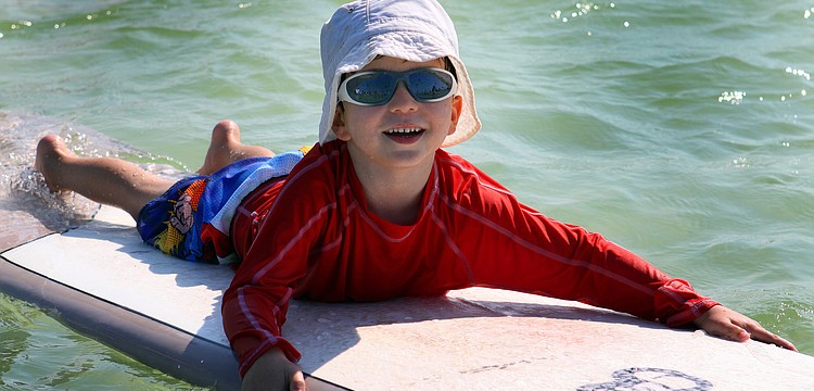 Harrison Troyan, 4 Â½, had a good time riding the waves during the Hang Ten for Autism surf event Saturday, Sept. 17, out at the Siesta Key Public Beach.