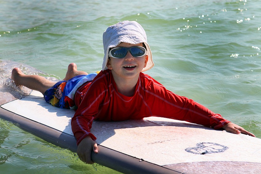 Harrison Troyan, 4 Â½, had a good time riding the waves during the Hang Ten for Autism surf event Saturday, Sept. 17, out at the Siesta Key Public Beach.