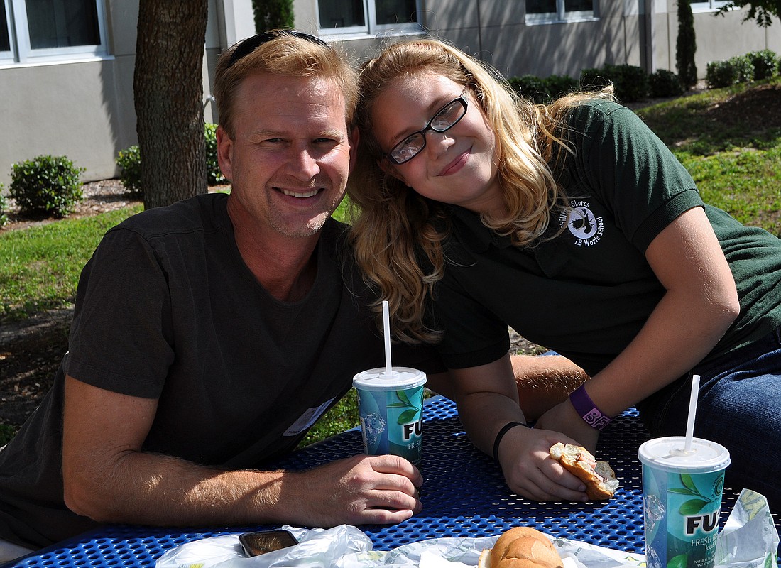 Bill and Anndee, 10, Edwards pose together during lunch Monday, Sept. 19, at Phillippi Shores Elementary.
