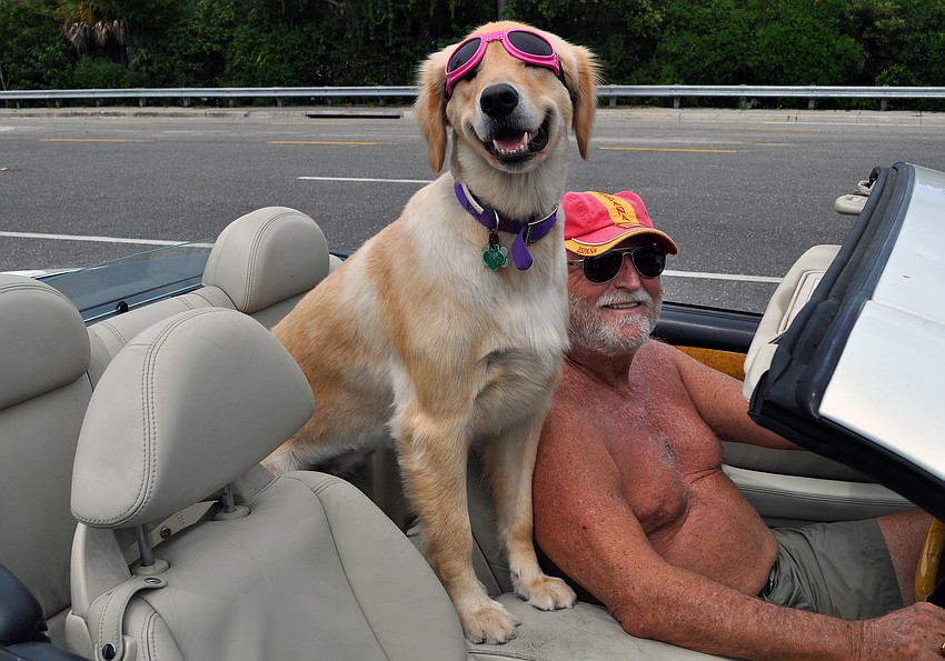 Don Lichter and Jocy, 2, take a ride to the bank in their convertible. 