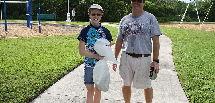 Megan and Steve Johnston took part in cleaning up the bay. Megan is apart of an environmental club at King Middle School, which participated in the day.