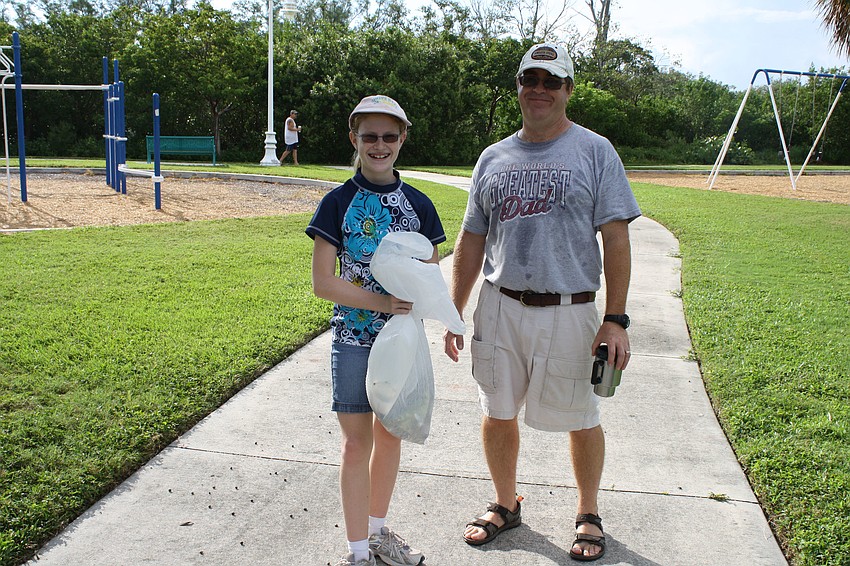 Megan and Steve Johnston took part in cleaning up the bay. Megan is apart of an environmental club at King Middle School, which participated in the day.