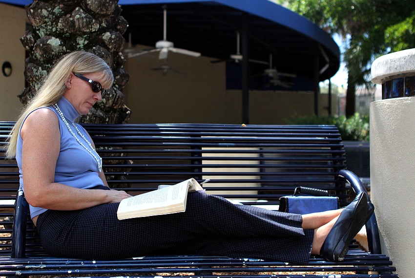 Dawn Davis enjoys catching up on her reading and having a macaroni salad for lunch during her lunch break from her work at Superior Bank.