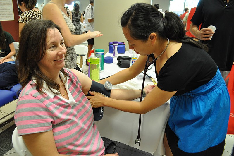 Penny Gillson gets her blood pressure taken by LECOM student Connie Pham.