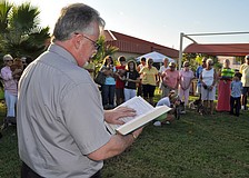 Deacon Tom Grant reads the pet blessing for the abused, those lost and the living Friday, Sept. 30, outside of Our Lady of Mount Carmel.