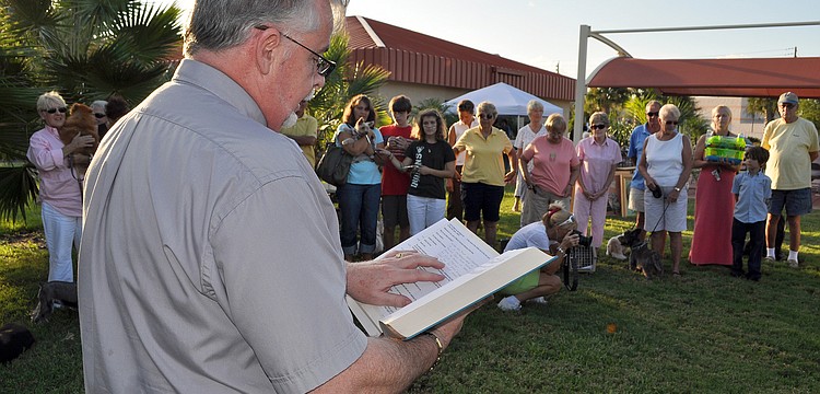 Deacon Tom Grant reads the pet blessing for the abused, those lost and the living Friday, Sept. 30, outside of Our Lady of Mount Carmel.
