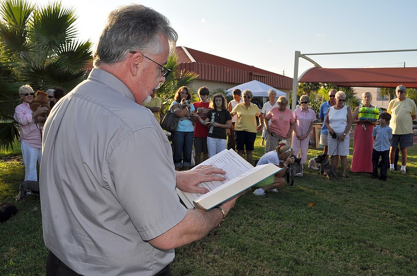 Deacon Tom Grant reads the pet blessing for the abused, those lost and the living Friday, Sept. 30, outside of Our Lady of Mount Carmel.