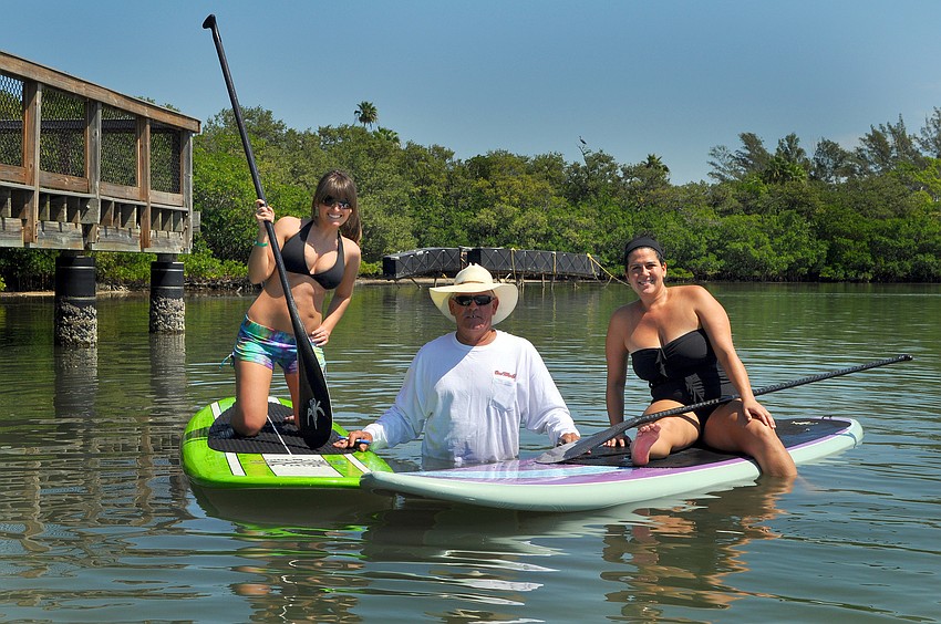 Rachel Livingston and Edy Attanasio pose with Jamie Hooks Saturday, Oct. 1 after getting their first cards during the poker run.