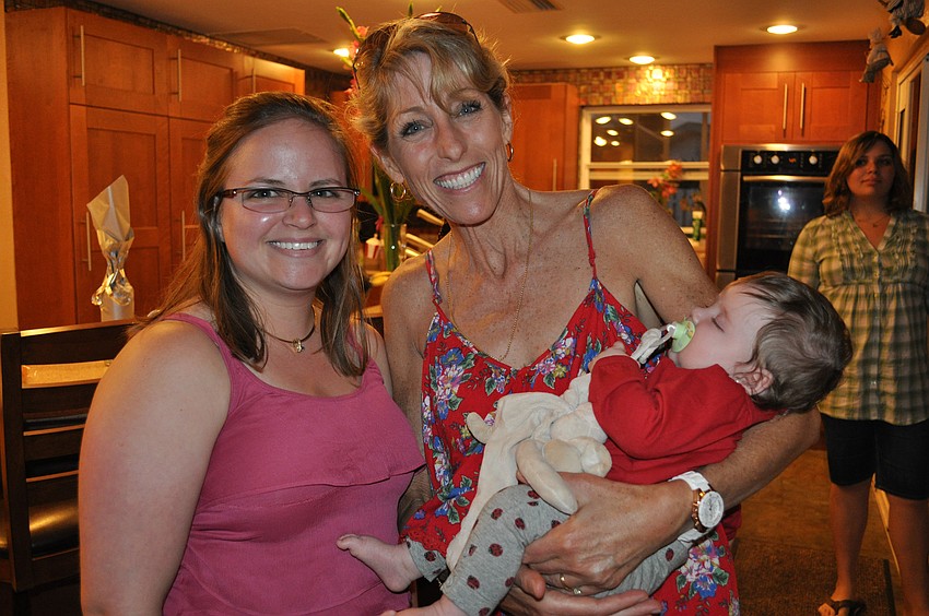 Lori Dorman holds Emily Foote's baby girl, Alana.