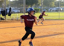 Nine-year-old short stop Kayla Estling races down the first base line after getting a hit in the first inning.