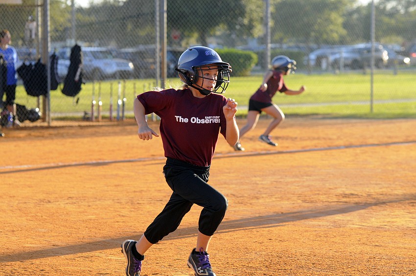 Nine-year-old short stop Kayla Estling races down the first base line after getting a hit in the first inning.