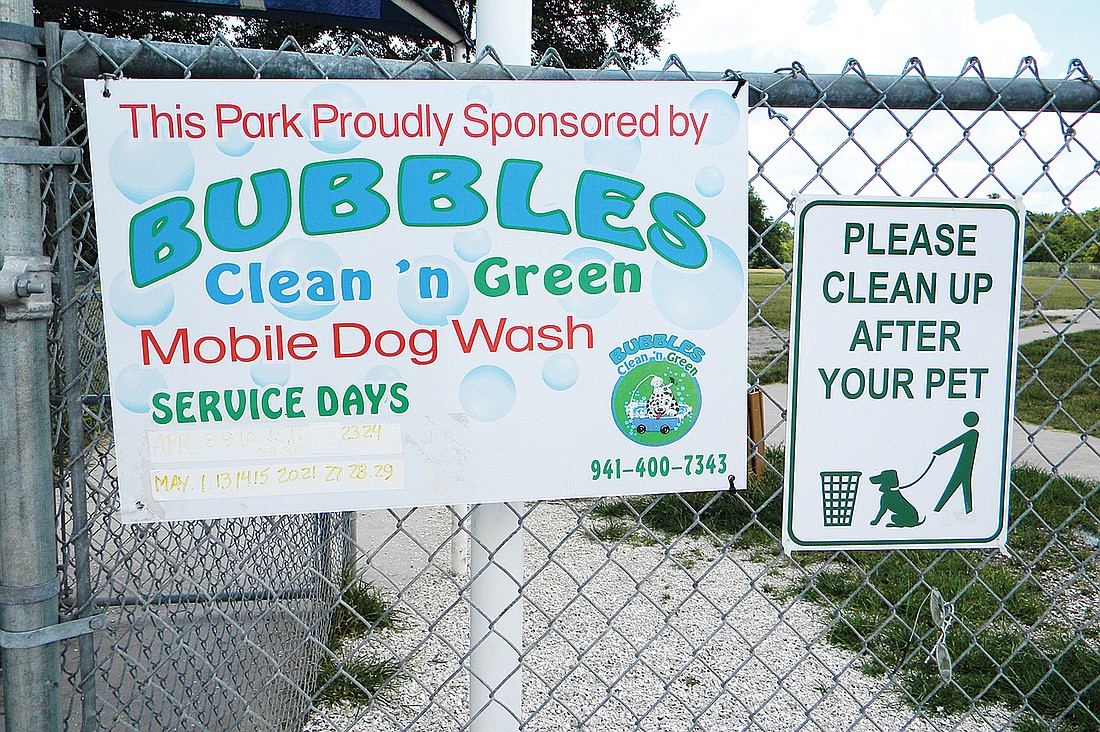 A sign for a dog-bathing service, put up in the spring at the 17th Street Dog Park, drew complaints from users of the facility, even though the business was labeled a sponsor. Photo by Norman Schimmel.