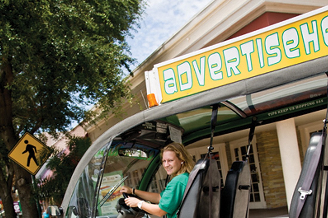 Briana O'Brien drives her Green Hopper on Main Street in downtown Sarasota. O'Brien has expanded her "green" service to the Key. To catch a free ride, call 706-5400. Courtesy photo.