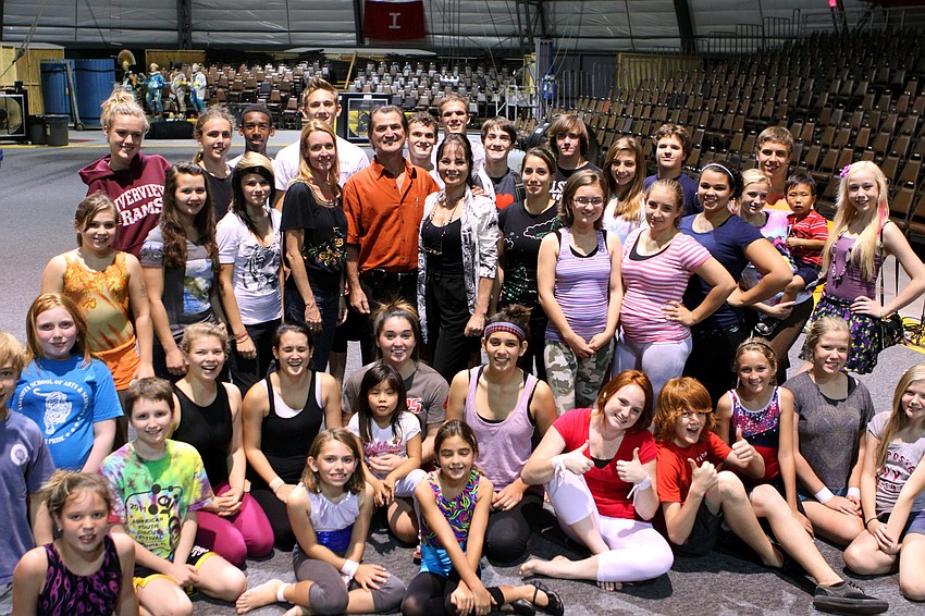 Susan Loeffler, Pedro Reis and Dolly Jacobs stand in the middle of a group of Sailor Circus students after the meeting.