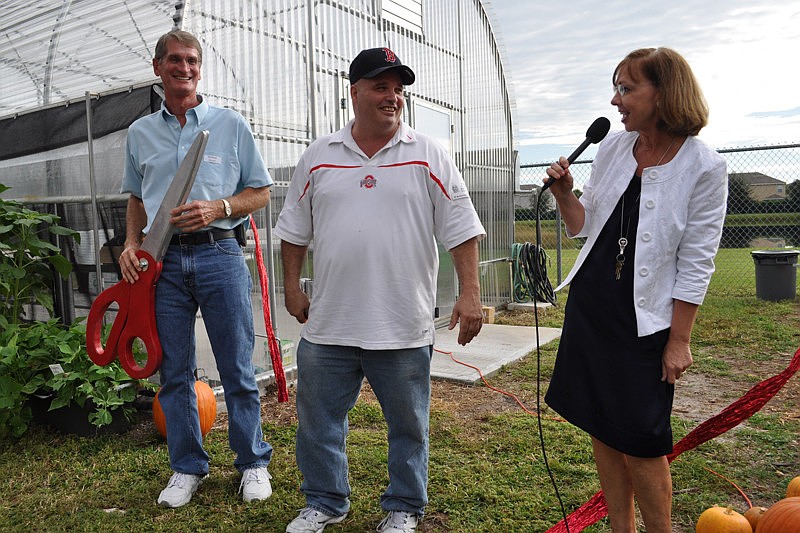 McNeal Principal Norma Scott, right, thanks John Falkner and Mark Campbell for their help in developing a garden and science lab at McNeal. The school celebrated the facility's opening today.