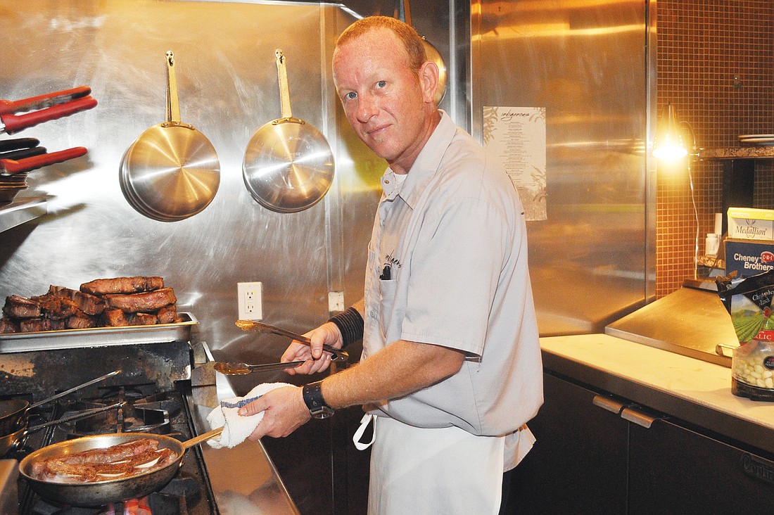 Chef/proprietor Steve Phelps sears meat in the kitchen at Indigenous.