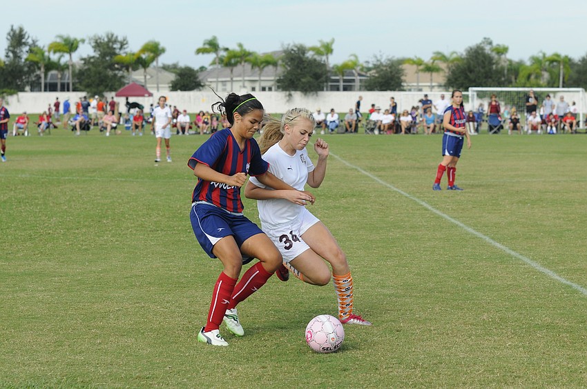 Kyra Himes, of Braden Riverâ€™s U13 team, battleâ€™s a Florida Revolution player for possession.