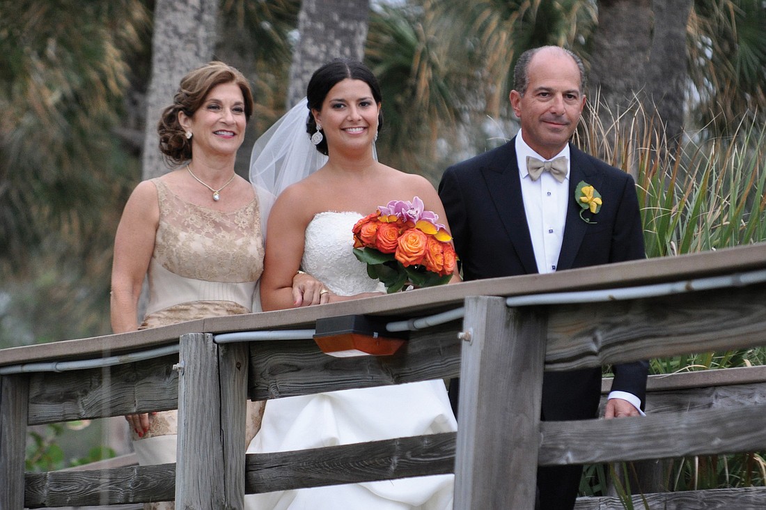 Donna and Jeff Lenobel escort their daughter, Jessica, the soon-to-be Mrs. Ian Paige, down the aisle.