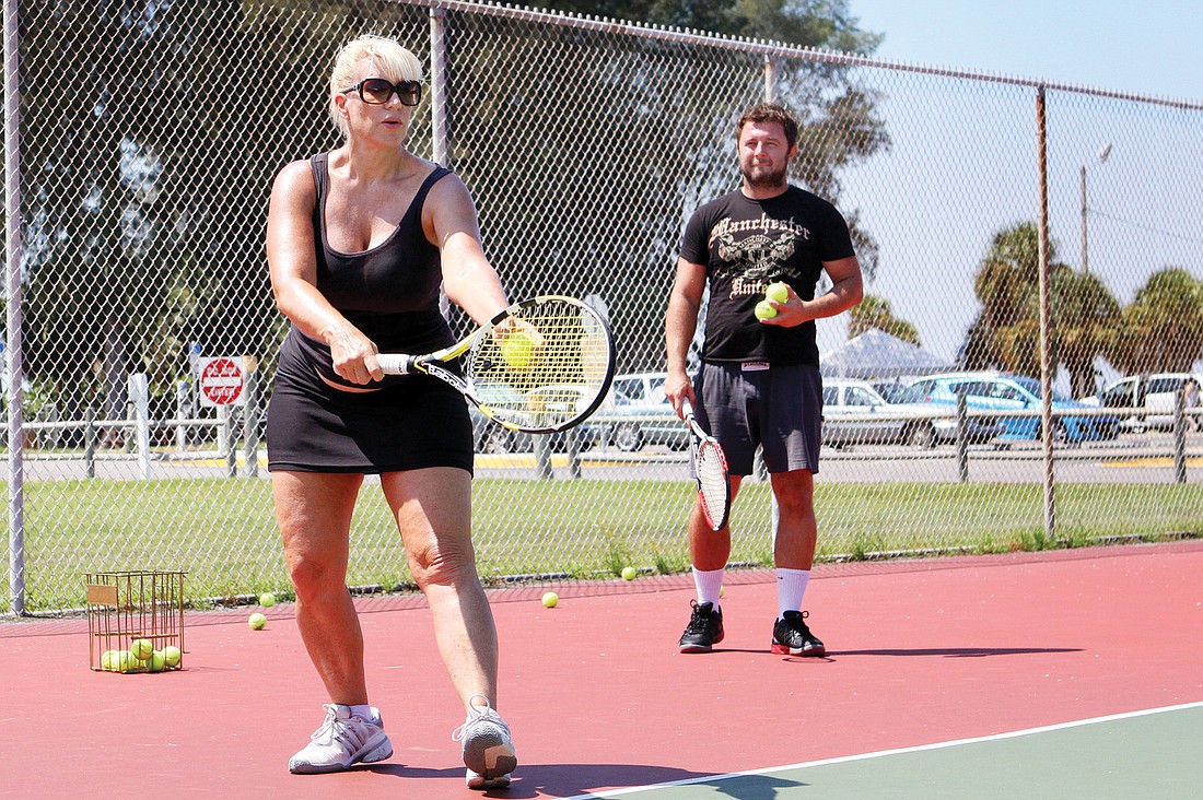 Michelle Zirkle works on her serve during her tennis lesson with pro Michael Skwira on a court at the Siesta Key Public Beach. Photo by Rachel S. O'Hara