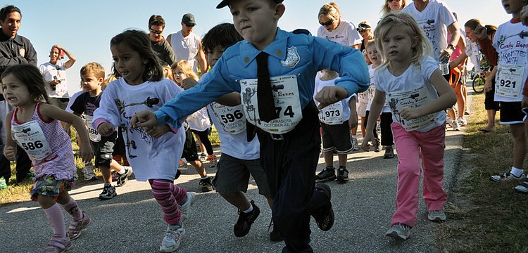 Dressed as a policeman, 4-year-old Ethan Armor proved to be one of the fastest runners.