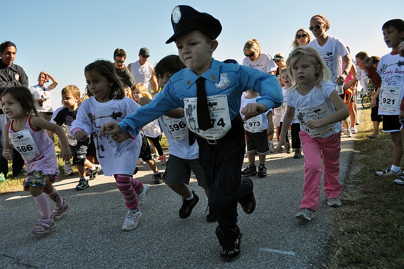 Dressed as a policeman, 4-year-old Ethan Armor proved to be one of the fastest runners.
