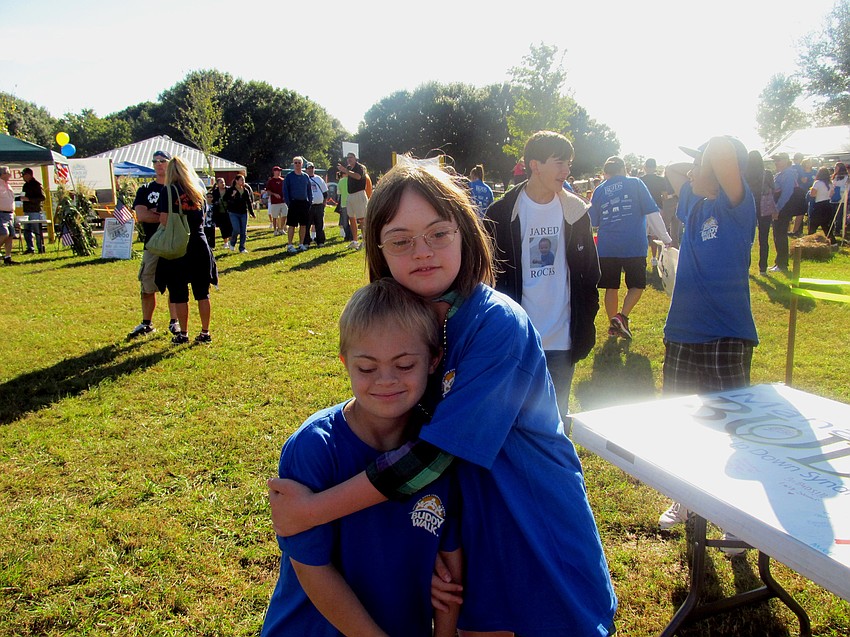 East County resident Joey Baar receives a hug from Ella Quaid during the Manasota BUDS 10th annual Buddy Walk Oct. 22, 2011.