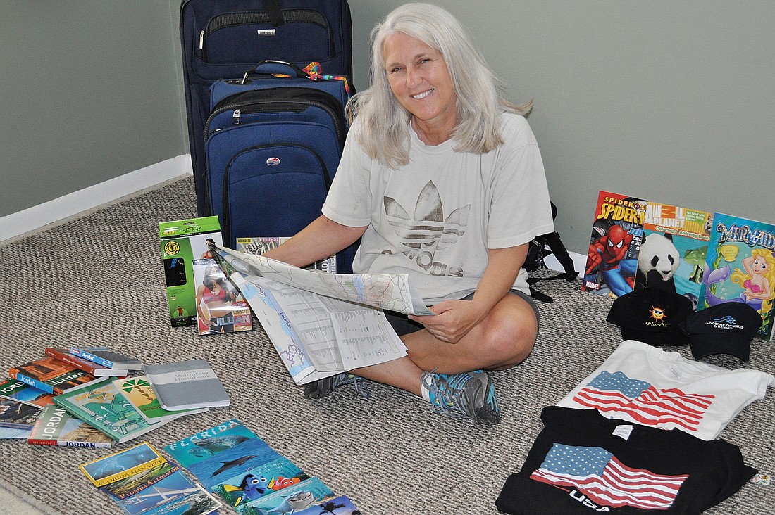 Lora Jason starts packing the things she will be taking with her to Jordan.