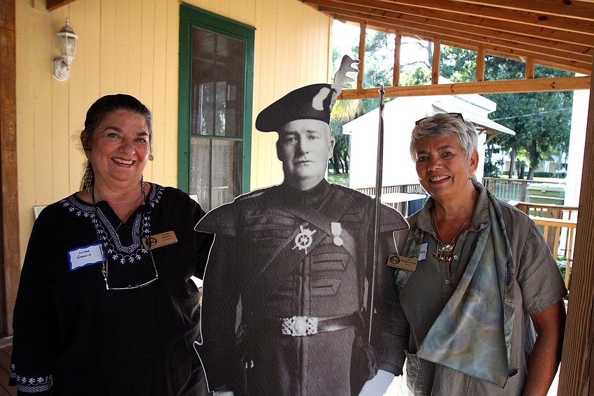 Linda Garcia and Jane Kirschner pose with a cutout of John Hamilton Gillespie.