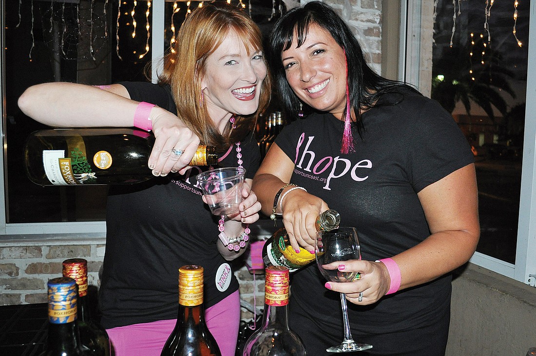 Emily Walsh and Fabiola Beckmann serve up wine at the event. Photo by Loren Mayo.