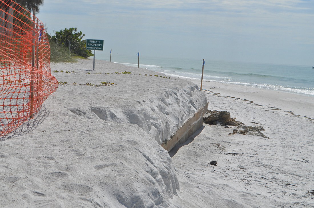 Public Works staff put the orange tape in place this week to direct beach-goers toward a safe beach access path.