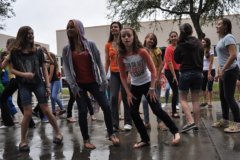 As part of a flash mob, about 100 students at Haile Middle School performed the dance from Michael Jackson's 'Thriller' video in the courtyard of the school  at 9:05 a.m.