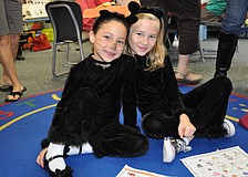 Marybeth Damico and Katie Dumas dressed in cat costumes.