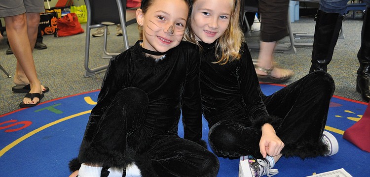 Marybeth Damico and Katie Dumas dressed in cat costumes.