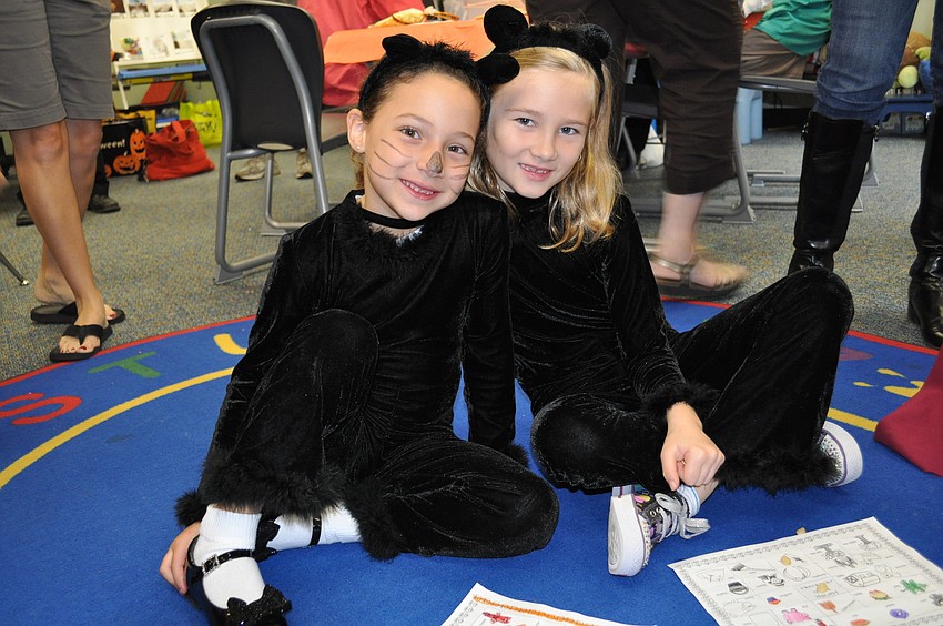 Marybeth Damico and Katie Dumas dressed in cat costumes.
