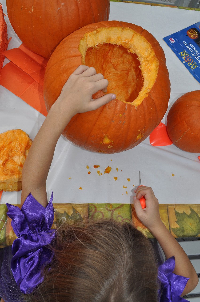 Ava Oâ€™Hara carves her pumpkin