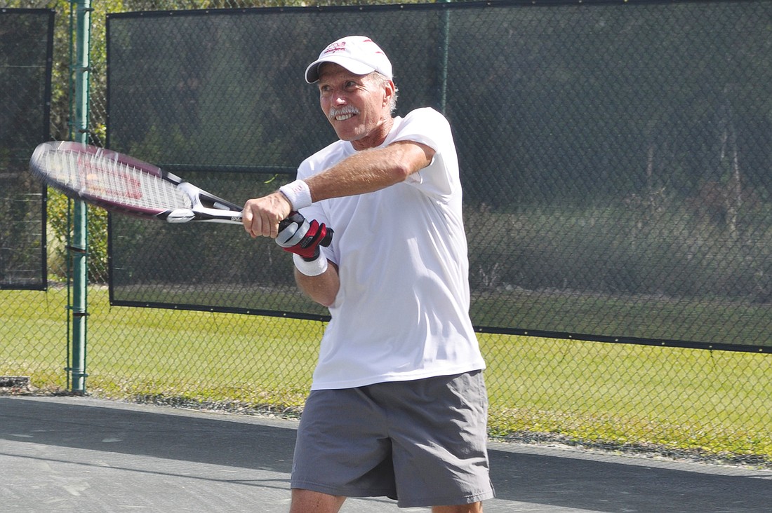 Scott Hase returns the ball in a doubles match Tuesday at the Longboat Key Public Tennis Center. His team won the match.  Photo by Mallory Gnaegy.