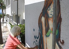 The Chalk Festival has integrated to Longboat Key. Artist Kitty Dyble Thompson from Milwaukee, Wis. is spray painting a mermaid on a wall facing the pool at Longboat Key Club and resort.