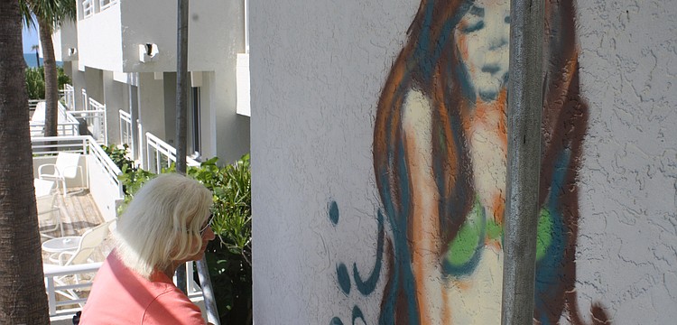 The Chalk Festival has integrated to Longboat Key. Artist Kitty Dyble Thompson from Milwaukee, Wis. is spray painting a mermaid on a wall facing the pool at Longboat Key Club and resort.