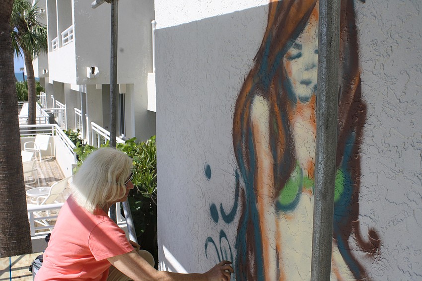 The Chalk Festival has integrated to Longboat Key. Artist Kitty Dyble Thompson from Milwaukee, Wis. is spray painting a mermaid on a wall facing the pool at Longboat Key Club and resort.