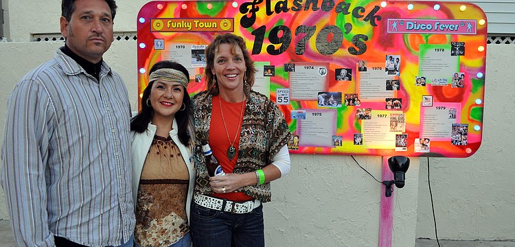 Gregory and Veronica Bever pose with Kay Kouvatsos by the funky timeline at Sandfest 2011, Friday, Nov. 4, at Siesta Key Beach Pavilion.