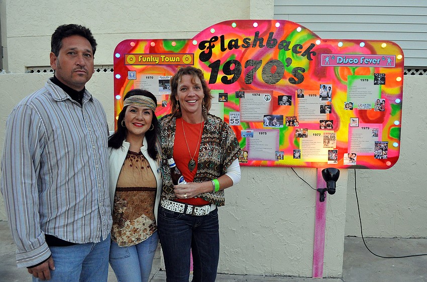 Gregory and Veronica Bever pose with Kay Kouvatsos by the funky timeline at Sandfest 2011, Friday, Nov. 4, at Siesta Key Beach Pavilion.