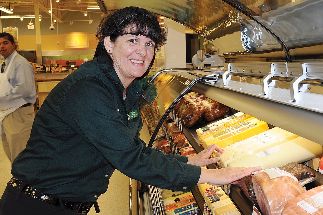 Connie Pittman helps prepare the Publix store for its grand opening.