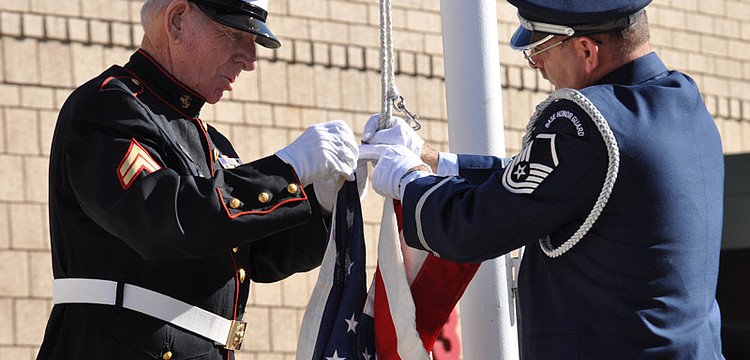 Cpl. Hurb Thompson and Master Sgt. Mark Corradino raised the flag.