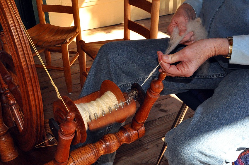 Anne Savage spun wool out on the back porch of the Bidwell-Wood house as part of Pioneer Day.