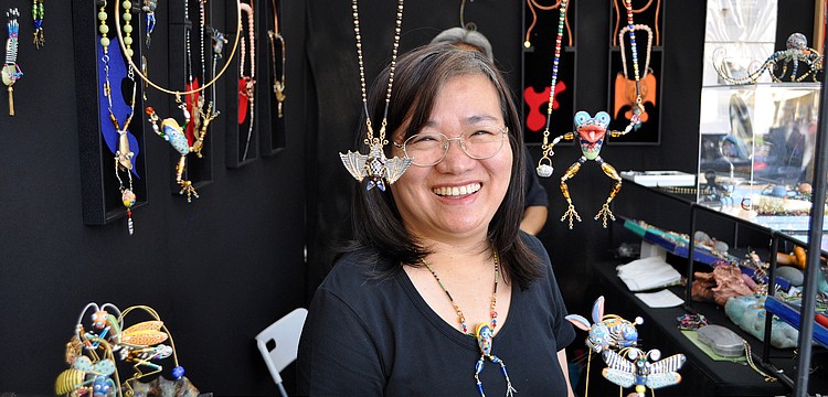 Cynthia Chuang smiles from behind the counter of Jewelry10, Sunday, Nov. 13 out on St. Armands Circle.