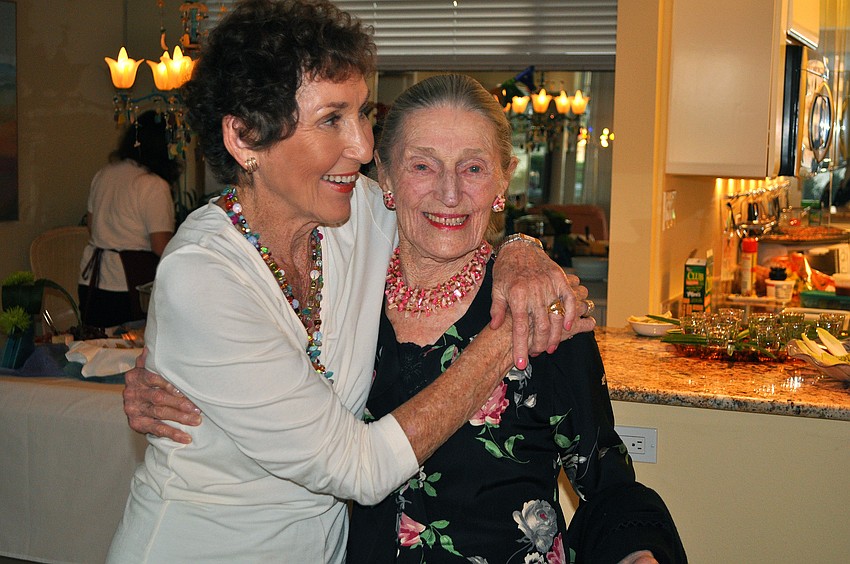 Ursula Pearson gets a big hug from Lois Lesser, the hostess of the Sands Point birthday celebration for Pearson's 100th birthday.