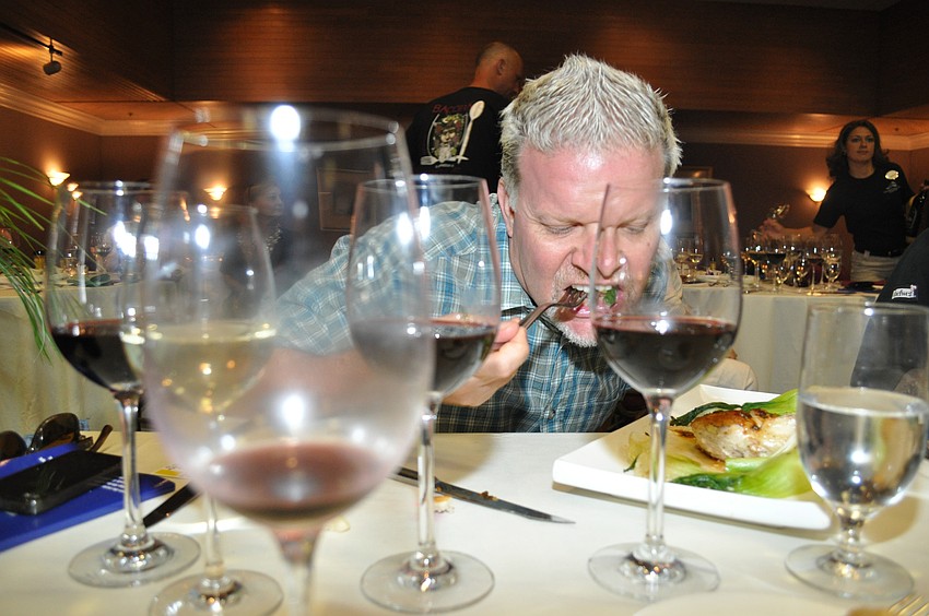 Dave Martin goes in for a bite of the chicken dish.