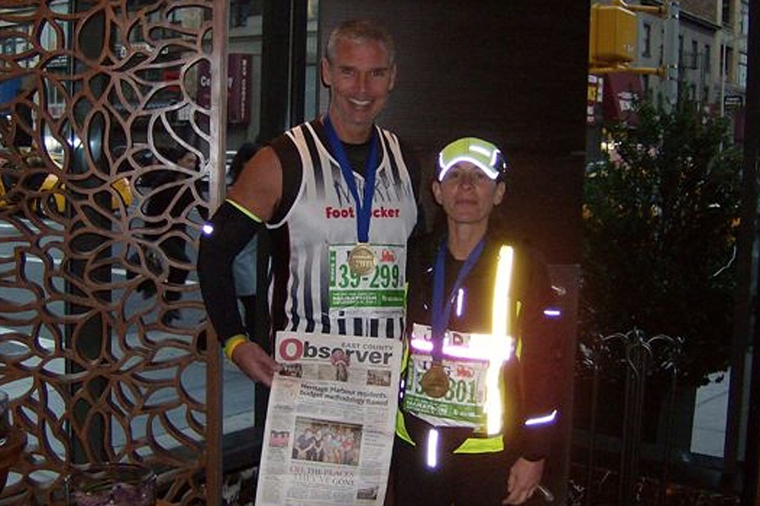 CUTLINE: Even after running 26.1 miles in the New York City Marathon, Jamey Murphy and Jodi Mailman had enough strength to hold up a copy of their favorite newspaper, the East County Observer.